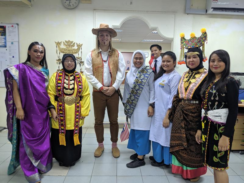 Kammerer is wearing a traditional Lundayeh costume to celebrate Merdeka Day, which is Malaysian Independence Day. Sabah celebrates in a way that is more focused on Sabah than Malaysia, Kammerer said, noting there are more than 30 indigenous ethnicities in Sabah. Kammerer is wearing a vest, hat, necklace, sword and khakis that men would typically wear to a wedding, and the women with headscarves are wearing traditional Bisaya costume.